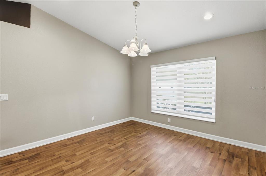 20781 Southwest 90th Loop Dunnellon, FL 34431 - Photo 14 of 46 a view of an empty room with wooden floor and a window
