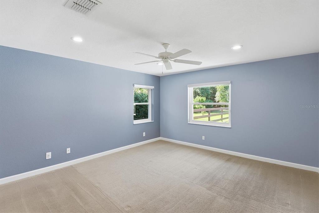 20781 Southwest 90th Loop Dunnellon, FL 34431 - Photo 16 of 46 an empty room with a window and a ceiling fan