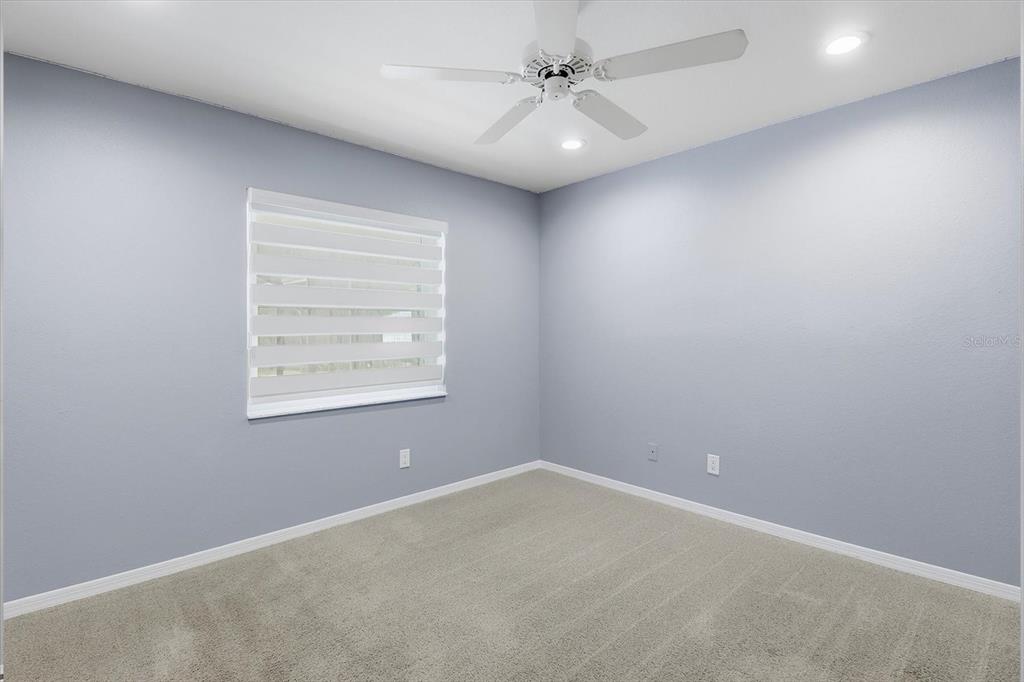 20781 Southwest 90th Loop Dunnellon, FL 34431 - Photo 25 of 46 an empty room with windows and fan