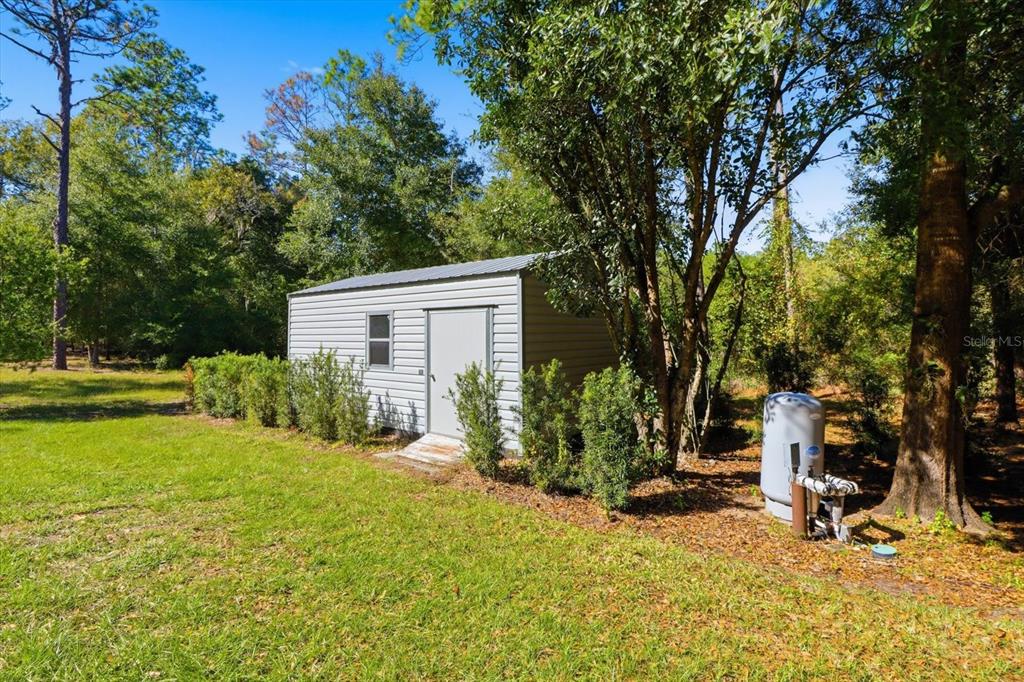 20781 Southwest 90th Loop Dunnellon, FL 34431 - Photo 45 of 46 a view of a house with backyard and trees