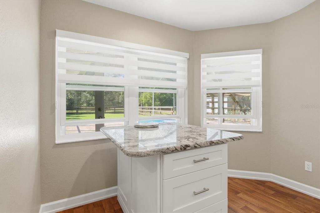 20781 Southwest 90th Loop Dunnellon, FL 34431 - Photo 9 of 46 a kitchen with granite countertop white cabinets and a window