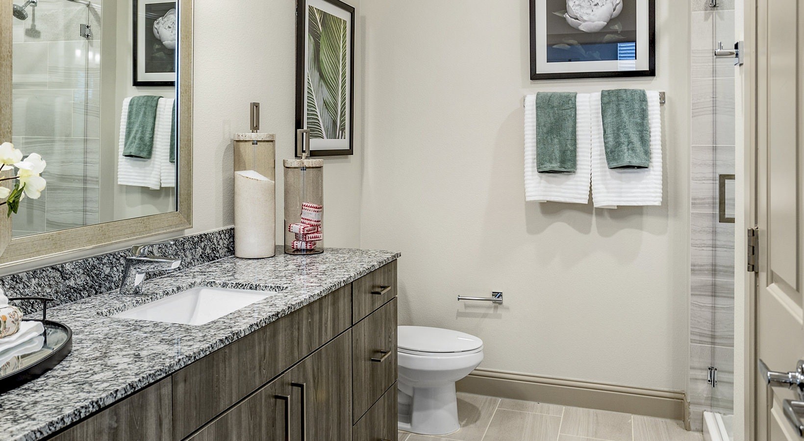 7100 Uvalde Road, Unit 2203 Houston, TX 77049 - Photo 15 of 28 a bathroom with a granite countertop sink a mirror and a toilet