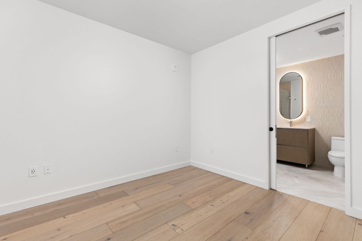 610 Davis Street, Unit 4008 Austin, TX 78701 - Photo 12 of 40 a view of a room with wooden floor and white walls
