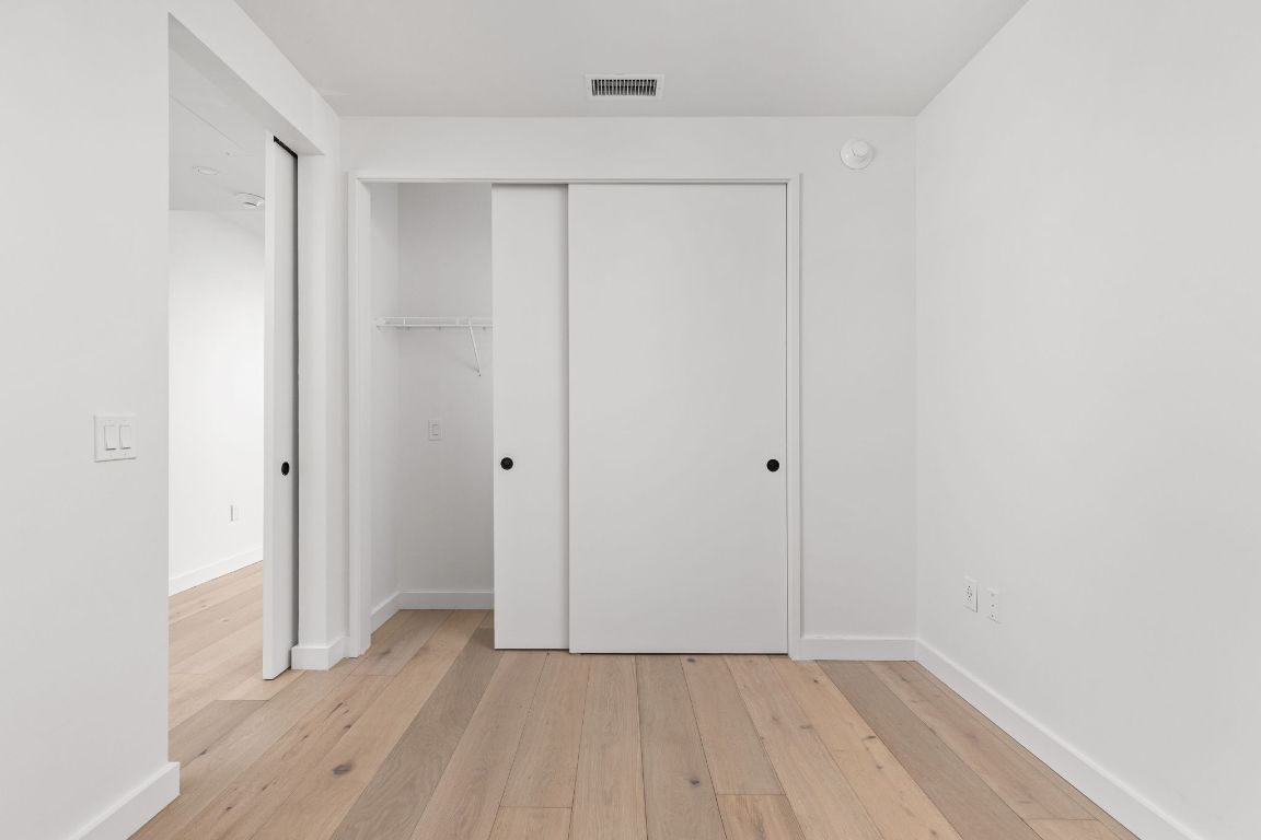 610 Davis Street, Unit 4008 Austin, TX 78701 - Photo 13 of 40 a view of an empty room with wooden floor