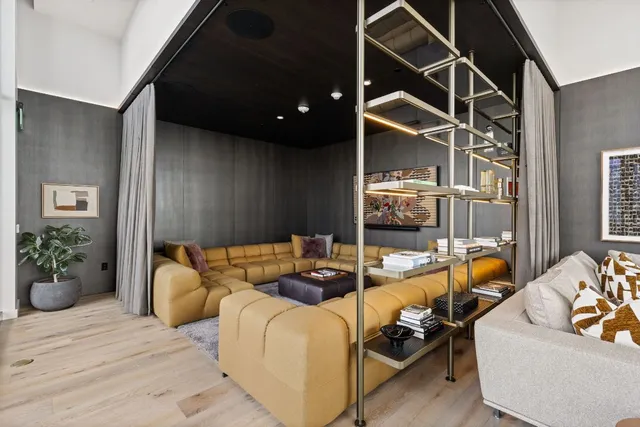 a living room with furniture a ceiling fan and a rug