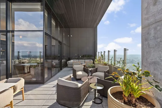 a balcony with chairs and stove