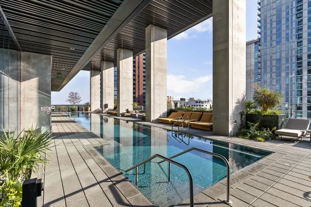 a view of a swimming pool with sitting area