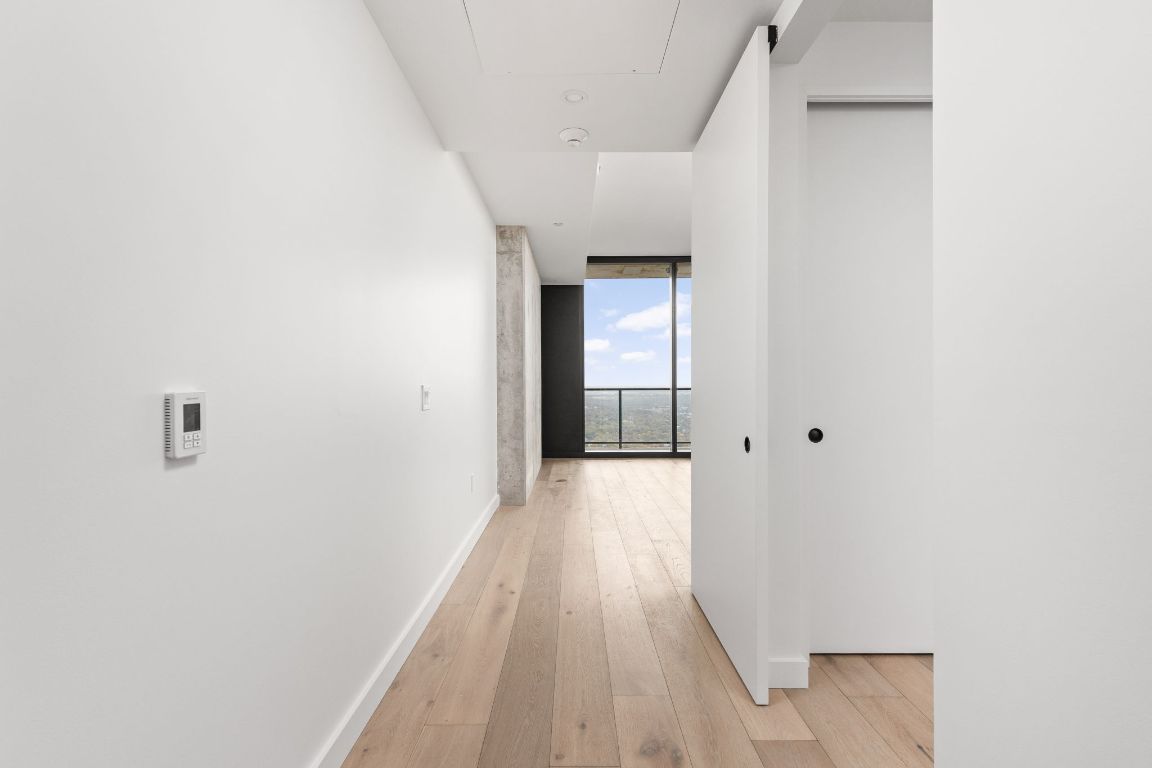 610 Davis Street, Unit 4008 Austin, TX 78701 - Photo 3 of 40 a view of a hallway with wooden floor