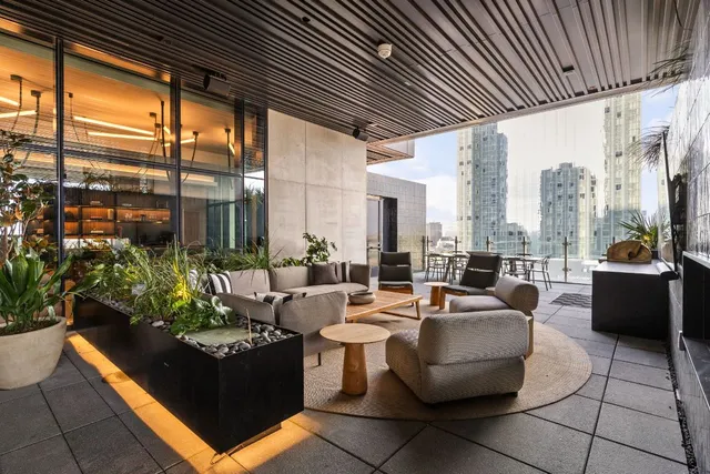 a view of a terrace with wooden benches and a couch