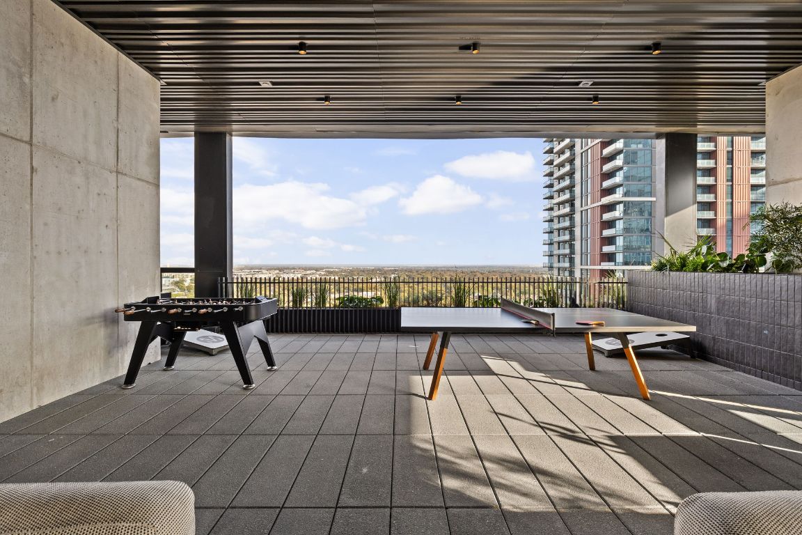 610 Davis Street, Unit 4008 Austin, TX 78701 - Photo 37 of 40 a view of a terrace with wooden benches and a couch