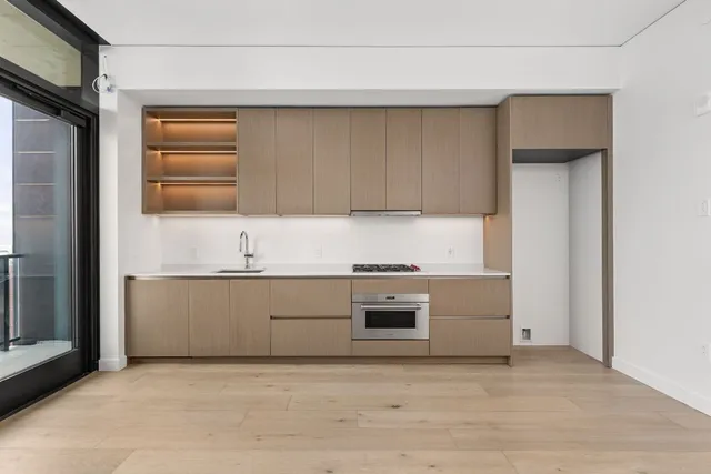 a kitchen with granite countertop a stove and a sink