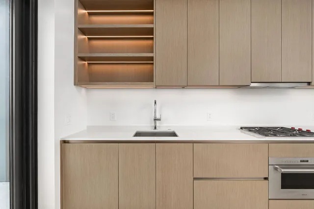 a kitchen with a sink and a refrigerator