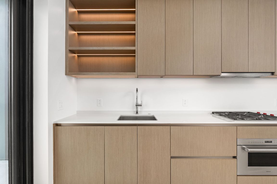 610 Davis Street, Unit 4008 Austin, TX 78701 - Photo 7 of 40 a kitchen with a sink and a refrigerator