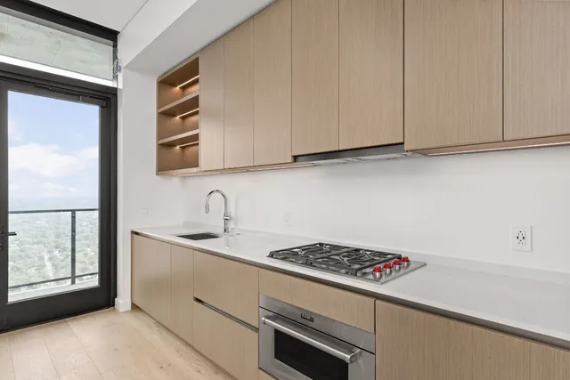 a kitchen with stainless steel appliances granite countertop a sink and a stove