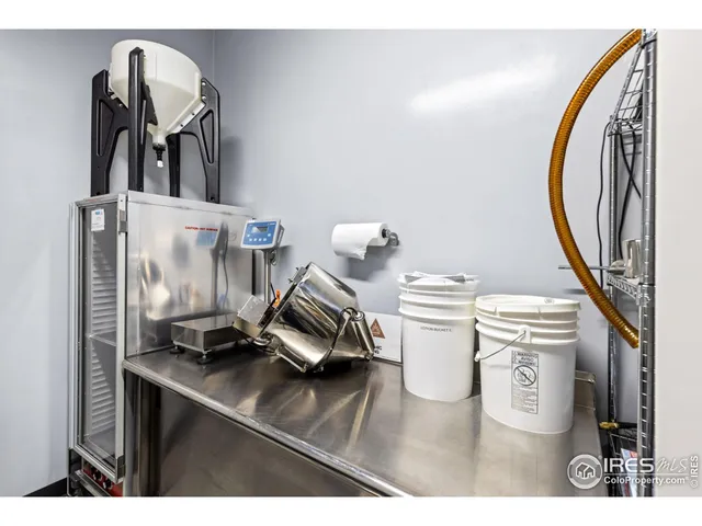 a kitchen with stainless steel appliances a stove a refrigerator and a dining table
