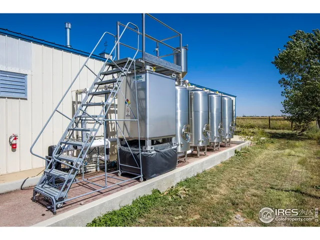 a view of a backyard with chairs and a table