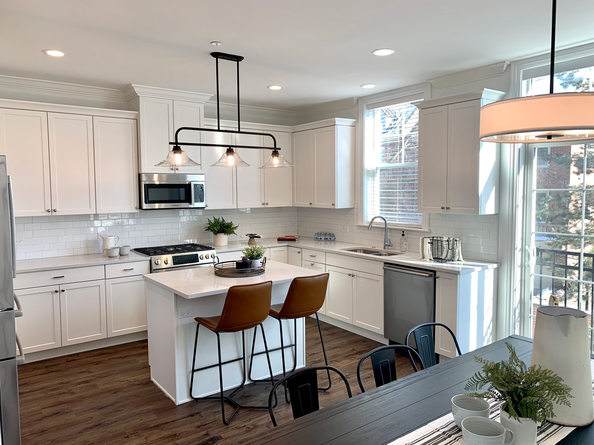 1751 Winnetka Road, Unit C Northfield, IL 60093 - Photo 3 of 6 a kitchen with stainless steel appliances granite countertop a stove top oven a sink dishwasher a dining table and chairs with wooden floor
