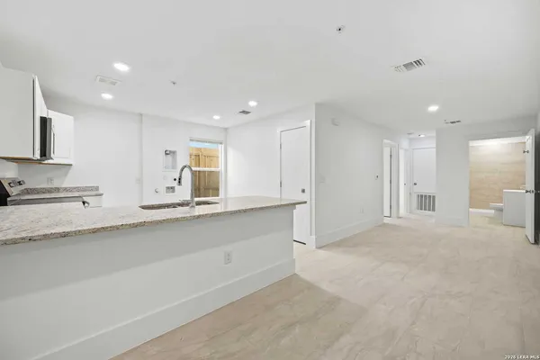 a view of kitchen with stainless steel appliances cabinets