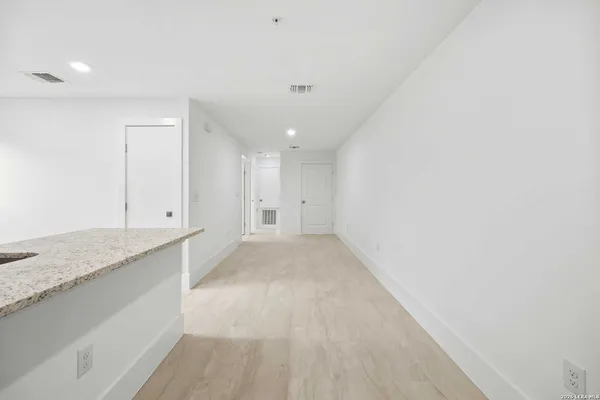 a view of kitchen with stainless steel appliances refrigerator sink and cabinets
