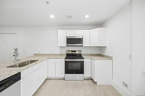 a kitchen with a sink granite counter tops and a sink