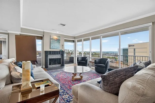 a living room with furniture large window and a fireplace