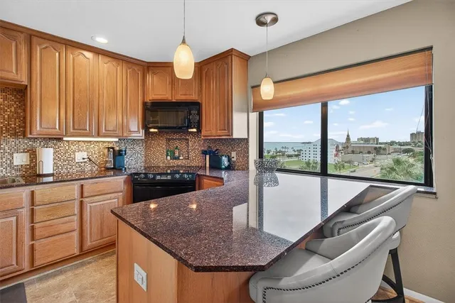 a kitchen with furniture a large window and a sink