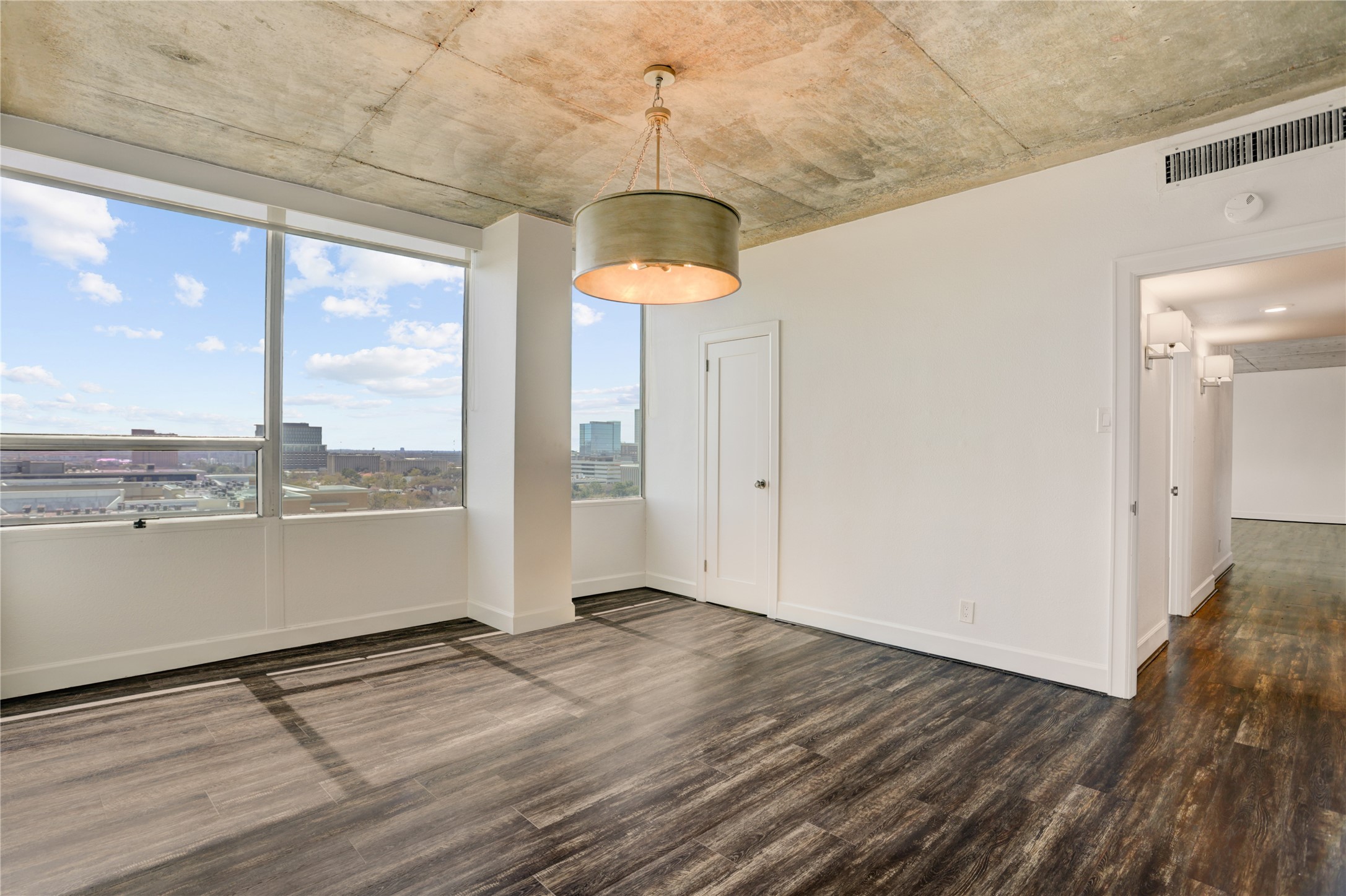 2701 Westheimer Road, Unit 12E Houston, TX 77098 - Photo 11 of 31 a view of a room with wooden floor and a floor to ceiling window