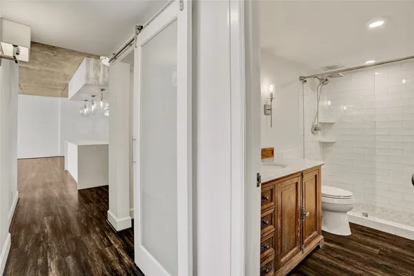 a bathroom with a toilet and a shower