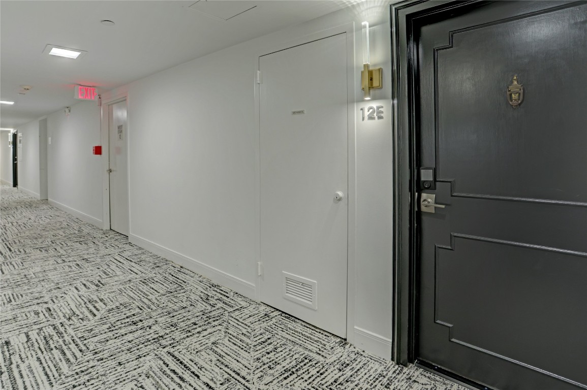2701 Westheimer Road, Unit 12E Houston, TX 77098 - Photo 17 of 31 a view of a hallway with wooden floor