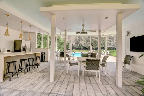 a dining room with furniture window and wooden floor