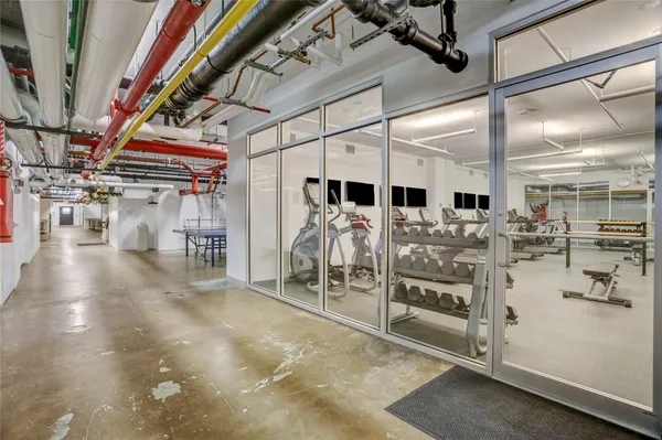 a view of a room with lots of gym equipment