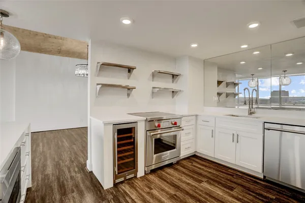 a kitchen with stainless steel appliances granite countertop a stove a sink and a refrigerator
