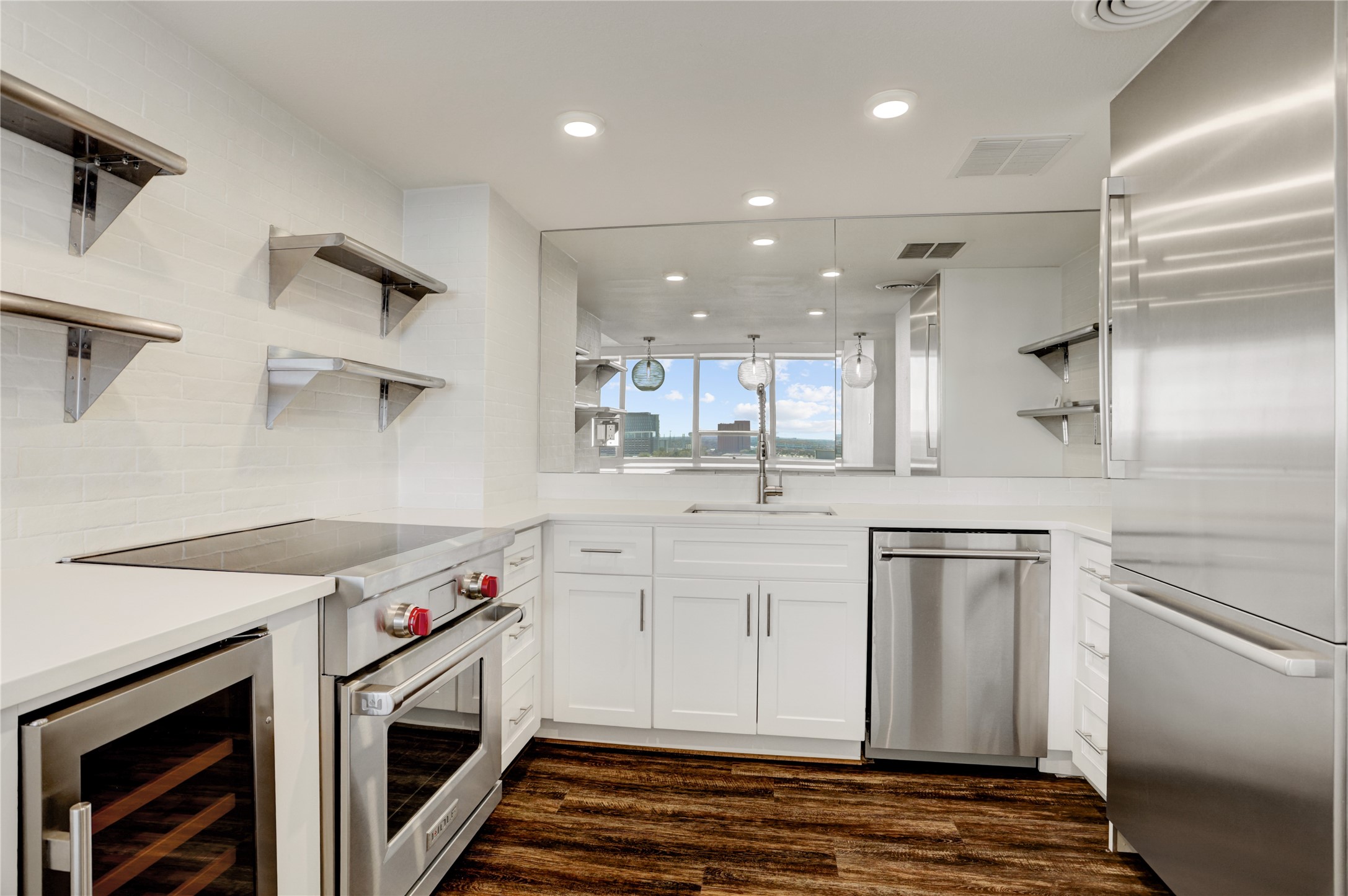 2701 Westheimer Road, Unit 12E Houston, TX 77098 - Photo 4 of 31 a kitchen with stainless steel appliances granite countertop a sink a stove and a refrigerator