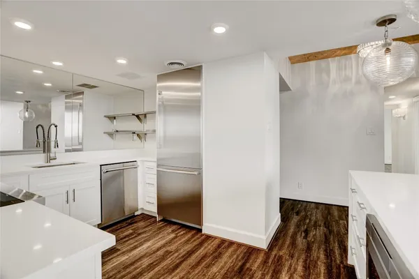 a kitchen with kitchen island a sink appliances and cabinets