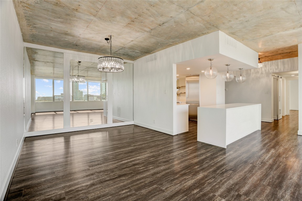 2701 Westheimer Road, Unit 12E Houston, TX 77098 - Photo 7 of 31 a view of a hallway with wooden floor and chandelier