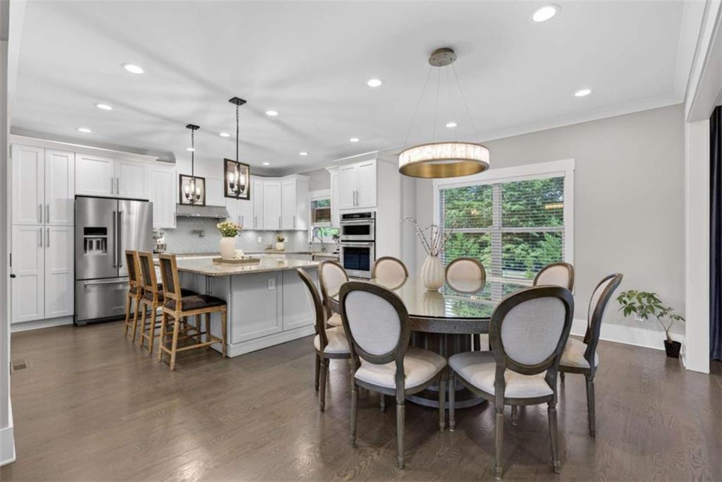 719 Austin Reynolds Road Bethlehem, GA 30620 - Photo 14 of 68 a kitchen with stainless steel appliances granite countertop a dining table chairs refrigerator and sink