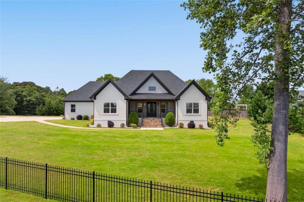 719 Austin Reynolds Road Bethlehem, GA 30620 - Photo 3 of 68 a view of a house with a big yard and large trees