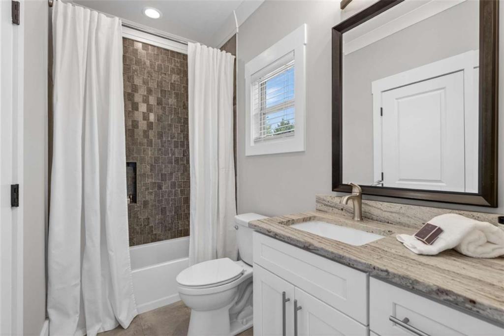 719 Austin Reynolds Road Bethlehem, GA 30620 - Photo 31 of 68 a bathroom with a granite countertop sink toilet and shower