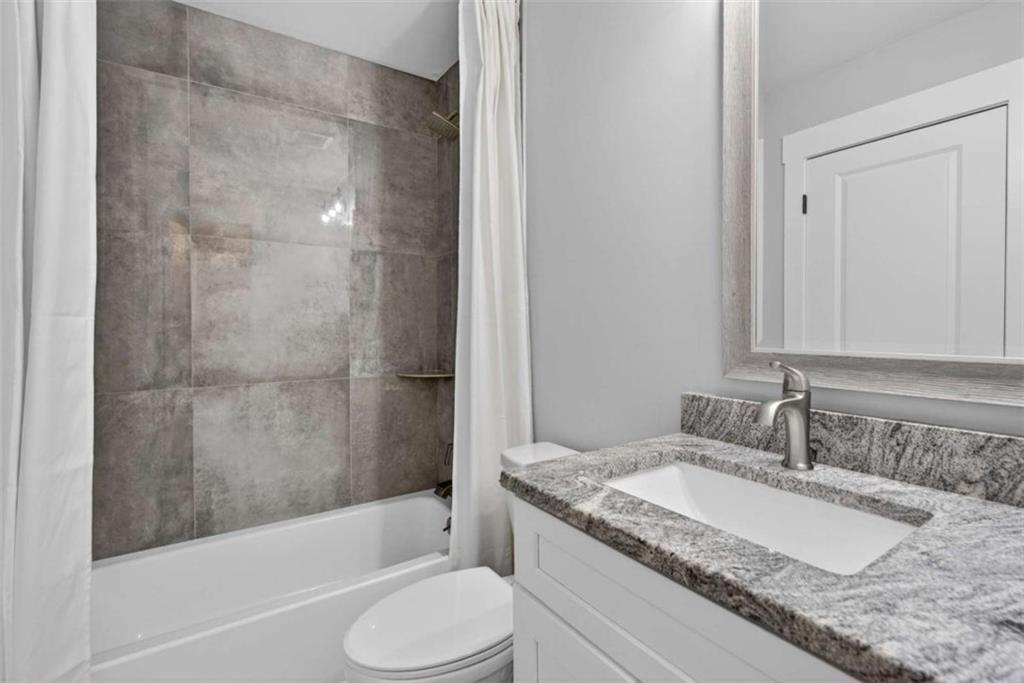 719 Austin Reynolds Road Bethlehem, GA 30620 - Photo 37 of 68 a bathroom with a granite countertop sink toilet and shower