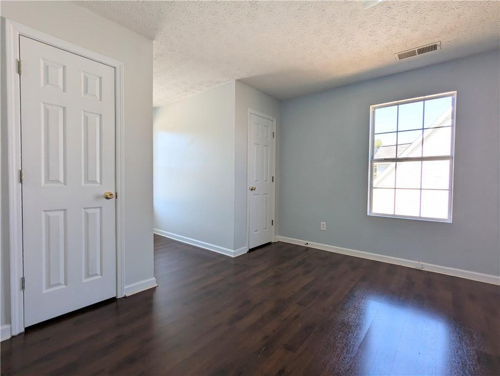 57 Inverness Trace Riverdale, GA 30274 - Photo 14 of 30 an empty room with wooden floor and windows