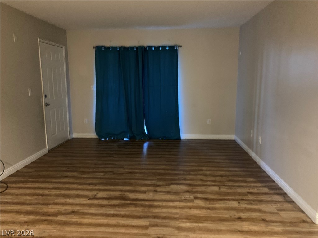 7885 West Flamingo Road, Unit 1003 Las Vegas, NV 89147 - Photo 4 of 7 A welcoming interior entry with rich wood-toned flooring and a convenient doorway.