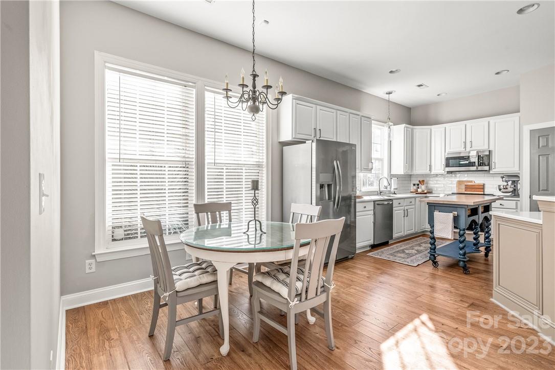 4108 Cedar Point Avenue Matthews, NC 28104 - Photo 14 of 41 a view of a dining room with furniture window and wooden floor