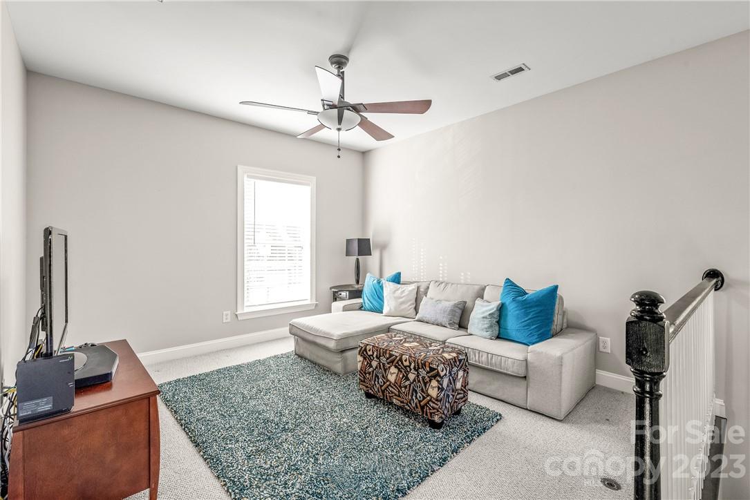 4108 Cedar Point Avenue Matthews, NC 28104 - Photo 22 of 41 a living room with furniture and a window