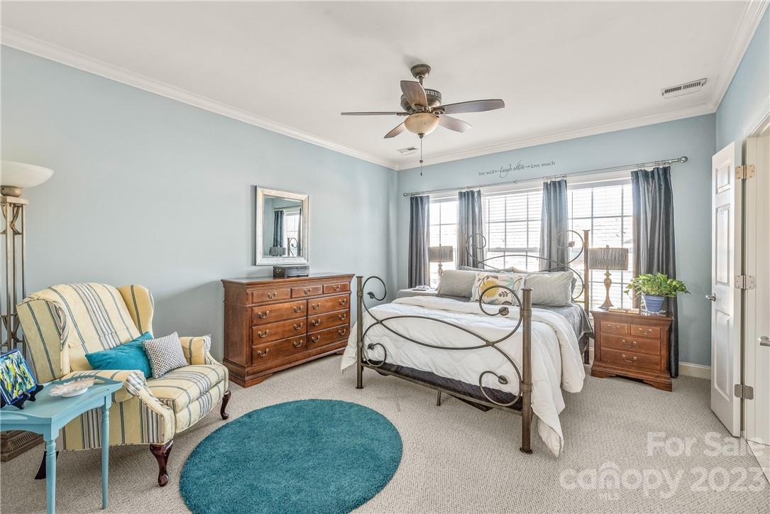 4108 Cedar Point Avenue Matthews, NC 28104 - Photo 23 of 41 a bedroom with a bed and a chandelier
