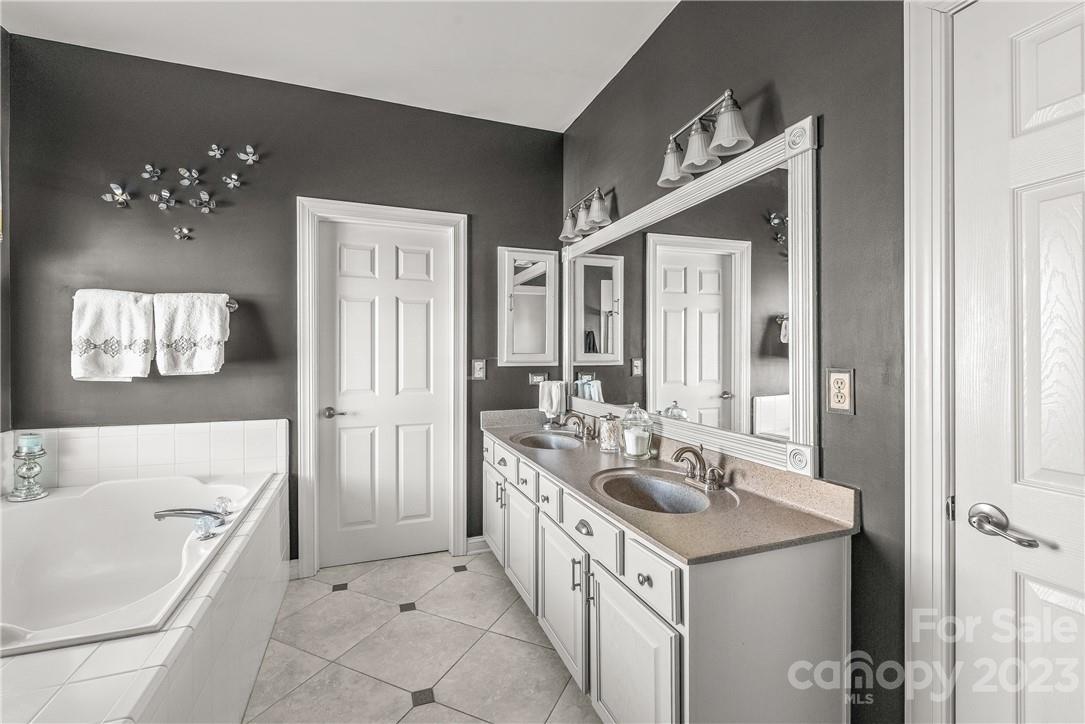 4108 Cedar Point Avenue Matthews, NC 28104 - Photo 24 of 41 a bathroom with a tub sink and mirror