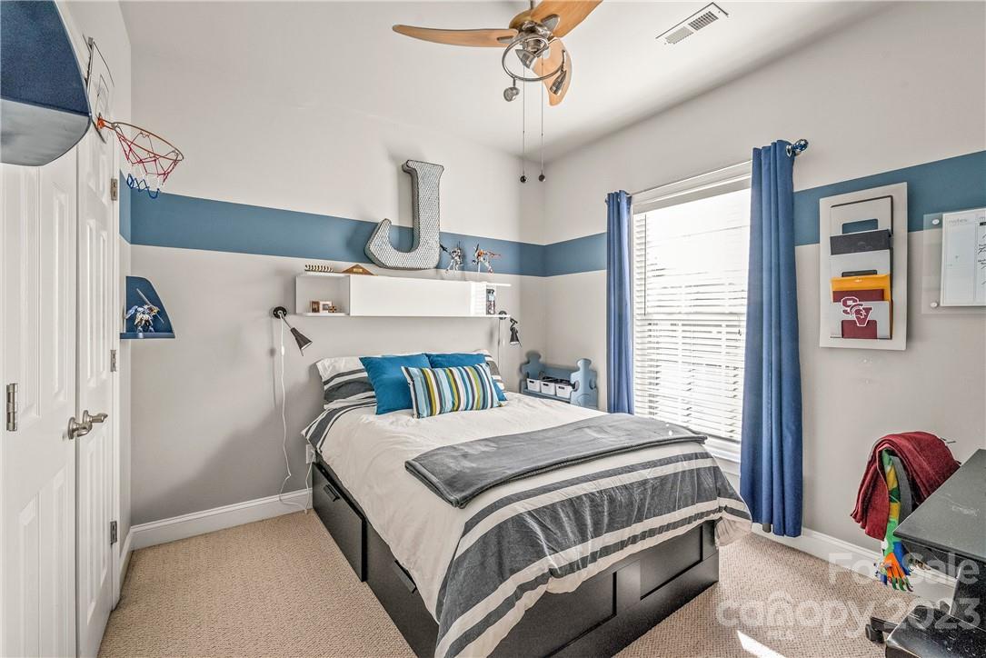 4108 Cedar Point Avenue Matthews, NC 28104 - Photo 26 of 41 a bedroom with a bed wooden floor and window