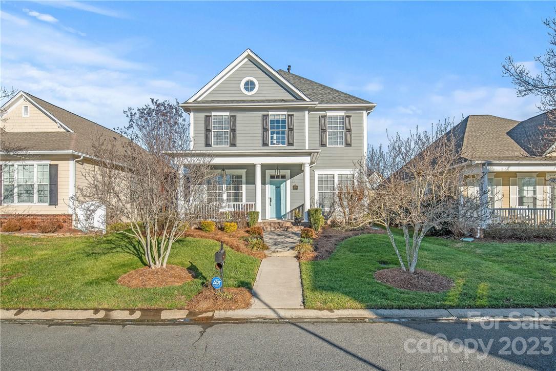 4108 Cedar Point Avenue Matthews, NC 28104 - Photo 3 of 41 a front view of a house with a garden and trees