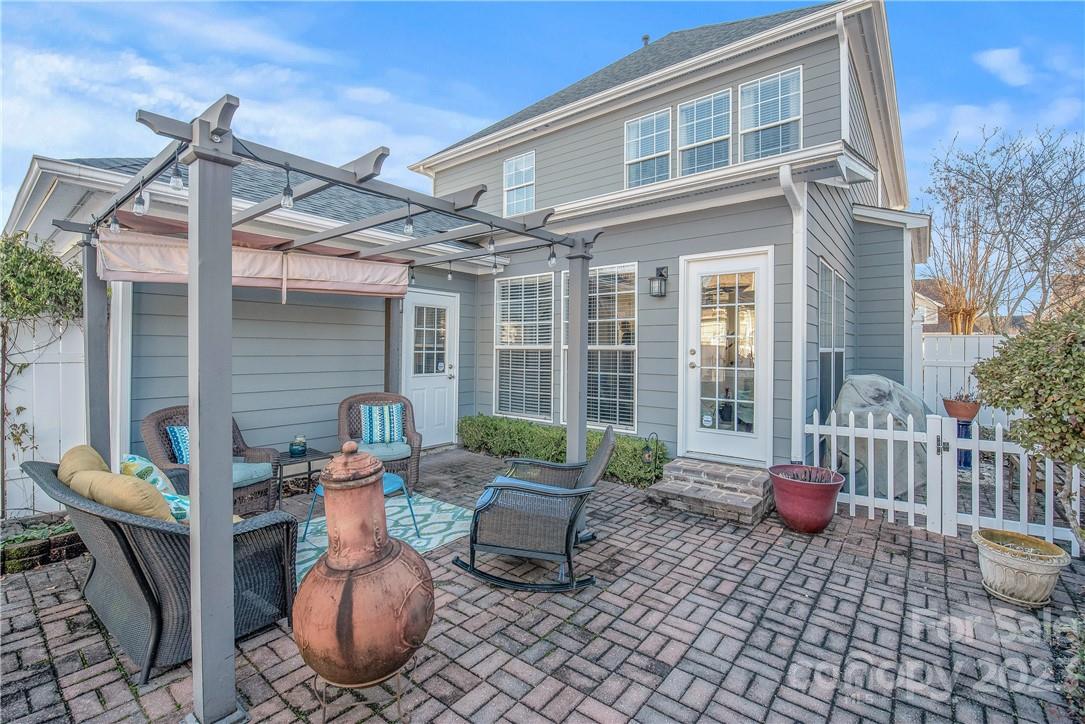 4108 Cedar Point Avenue Matthews, NC 28104 - Photo 32 of 41 a view of a patio with couple of chairs and a fountain