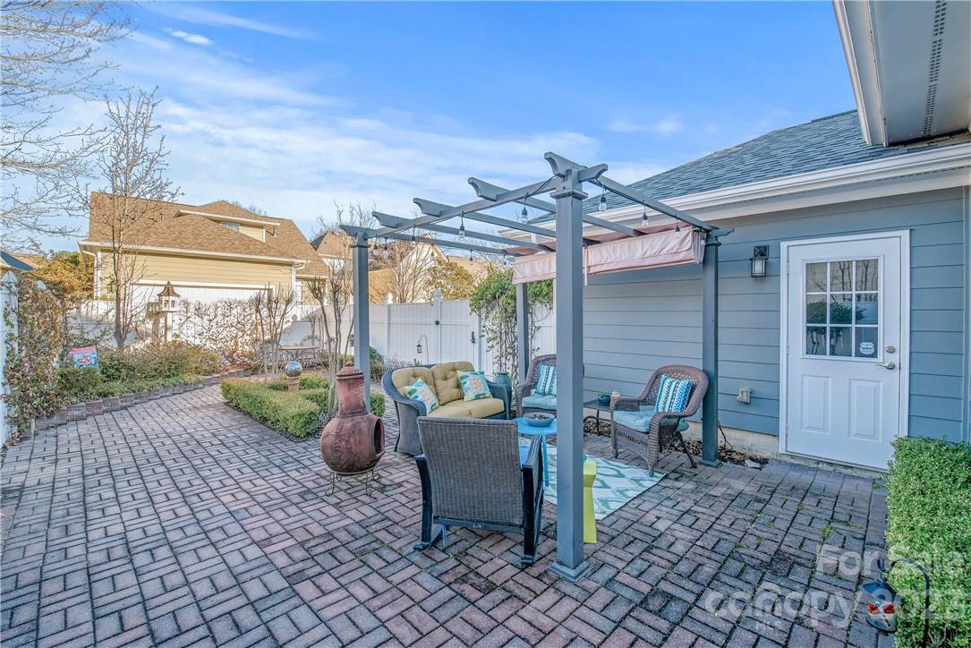 4108 Cedar Point Avenue Matthews, NC 28104 - Photo 33 of 41 a view of a patio with table and chairs and potted plants