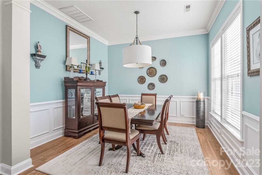 4108 Cedar Point Avenue Matthews, NC 28104 - Photo 10 of 41 a dining room with furniture a chandelier and wooden floor